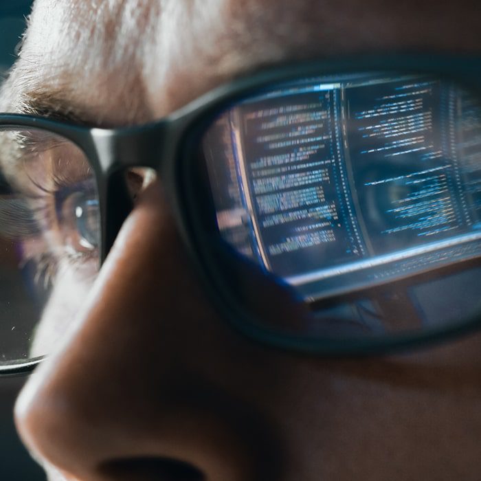 Code reflected in glasses